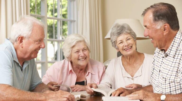 Group Of Senior Couples Attending Book Reading Group | The Cons of Confinement: Why Seniors Need A Social Life