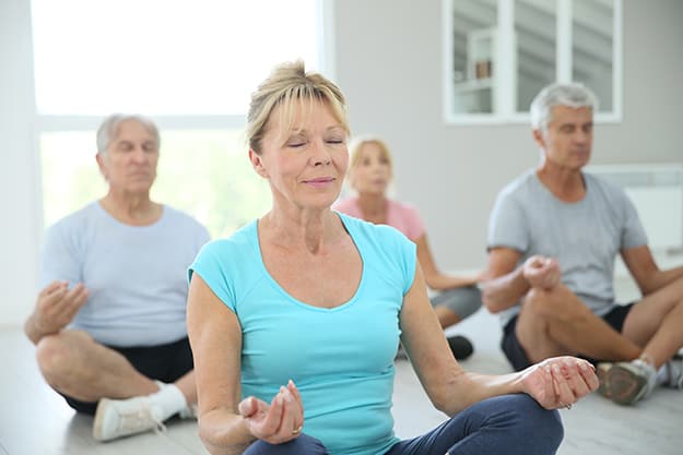 Group of elderly people doing yoga | 9 Mind Stimulating Activities Great For Seniors