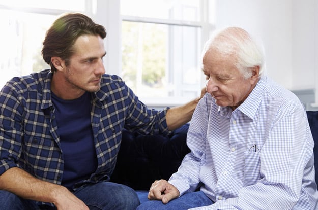 concerned-adult-son-comforting-elderly-father-What-Should-You-Consider-Before-Accepting-Full-time-Caregiver-Responsibilities-ss