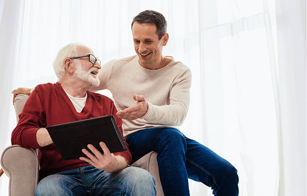 Positive delighted males discussing modern technologies | 8 Proven Ways To Effectively Communicate With Your Aging Parents