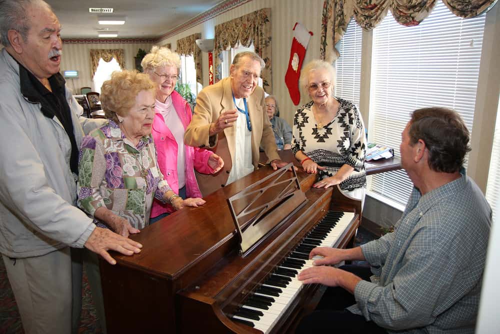 people sing along a Piano and having fun