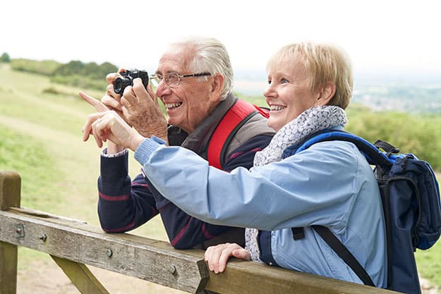Senior-Couple-Hiking-In-Countryside | 9 New Hobby Ideas You Should Introduce To Your Parents