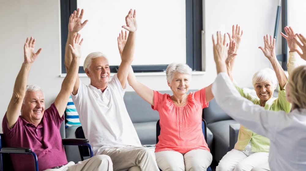 BLOG-12-Oaks---Group-Of-Seniors-In-Fitness-Class-H…ts-And-Preparations-Of-Chair-Exercises_feature | 5 Chair Exercise Routines For Seniors With Limited Mobility