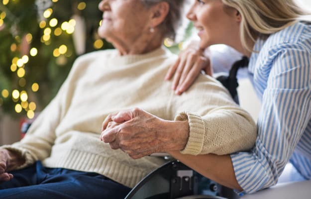 BLOG_12O_A-senior-woman-with-a-health-visitor_The-12-Oaks-Community-Standard | 5 Winter Safety Tips For Seniors & Caregivers