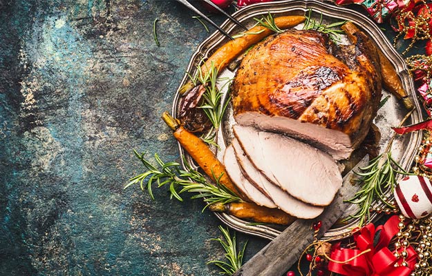 Christmas-ham-served-with-roasted-vegetables-and-festive-decorations-on-vintage-background-Spicy-Maple-Glazed-Ham