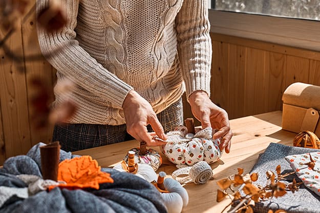 Woman-making-colorful-fabric-pumpkins | 6 Fun Thanksgiving Activities You Can Do With Your Parents