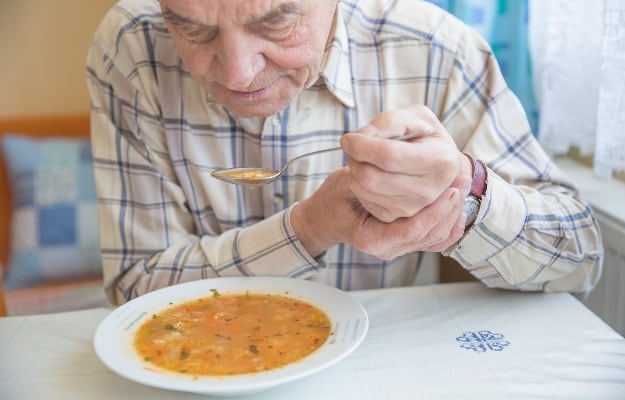 elderly man eating with both hands alone | 4 Common Senior Eating Problems and How to Combat Them