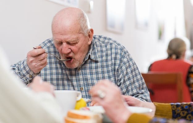 senior man eating soup | 4 Common Senior Eating Problems and How to Combat Them