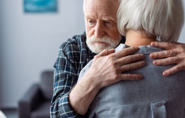 BLOG-12-Oaks---back-view-of-senior-woman-hugged-by…n-dementia------How-to-Cope-with-Dementia | Guide To Understanding & Coping With Dementia Behavior