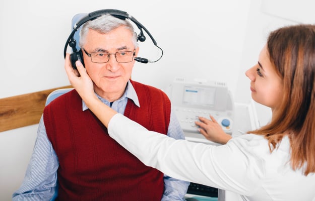 audiologist-during-ear-exam_Hearing-Test_ss_body | 9 Recommended Preventive Health Care Screenings For Seniors