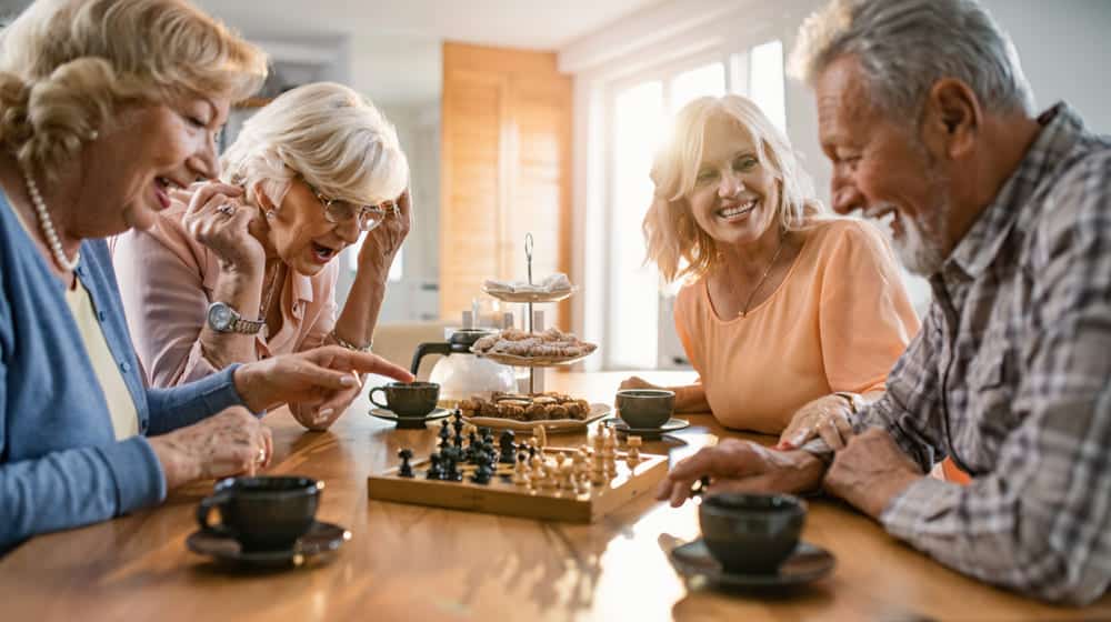 group-happy-seniors-playing-chess _ 8 Memory Board Games Perfect For Your Beloved Family Members feat ss