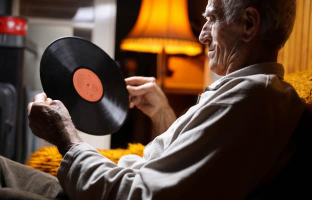 old-man-holds-a-vinyl-record-in-a-hand-----------Other-Benefits-of-Relaxing-Music-to-Senior-Citizens_ss_body