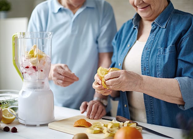 12Oaks-Senior people peeling fruits for smoothie-ss-5.Fresh Smoothies