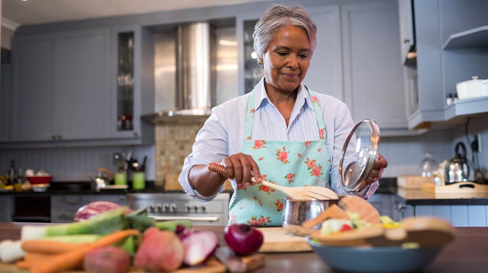 12Oaks-Senior woman preparing food in kitchen at home-ss-5 Easy to Prepare Light Lunch Ideas Your Parents Will Love