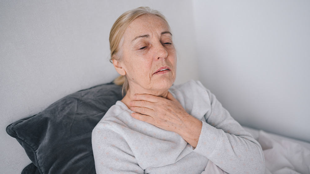 12Oaks-Senior woman sick, throat pain-ss-Natural Ways to Treat Sore Throat in Older Family Members-Feature