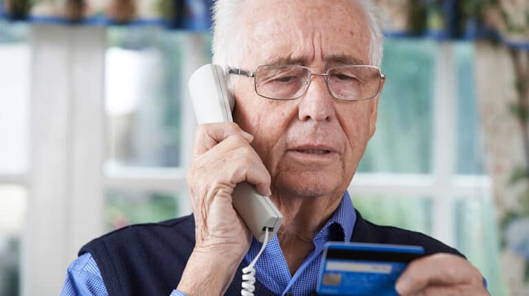 12Oaks-senior-man-giving-credit-card-details-ss-How to Protect Your Parents From Online and Telemarketing Scams