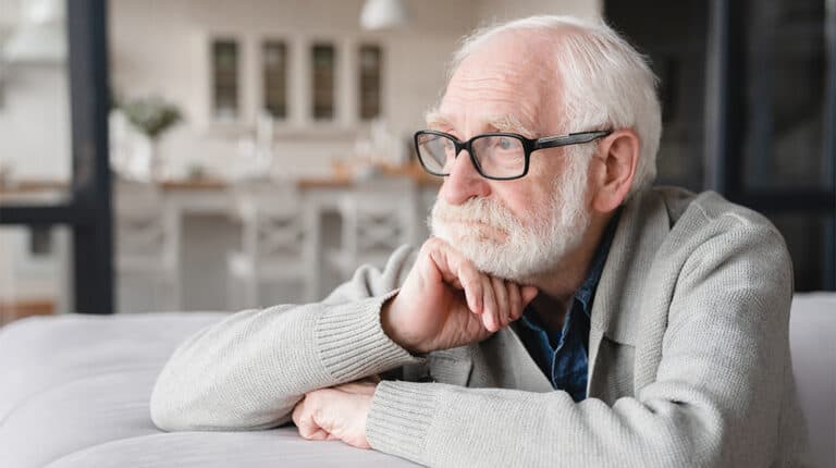 Sad tired ill sick lonely disappointed caucasian old elderly senior man grandfather sitting on the sofa couch-ss-How to Support an Aging Brain-Feature