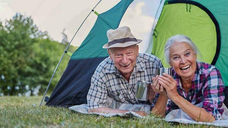 two-seniors-is-smiling-while-staying-in-the-tent--4-Benefits-of-Camping-for-Seniors-and-How-Can-They-Enjoy-It----ss-feat