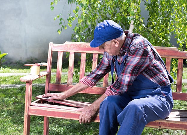 12Oaks-Senior man repairing old bench in garden-ss-4. Gardening Boosts Brain Health