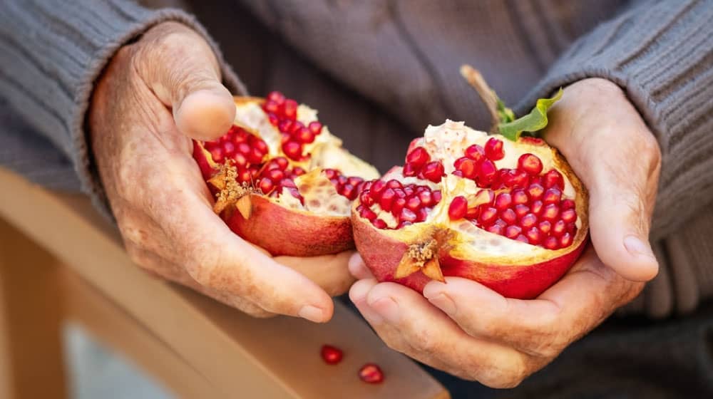 seniors-hand-holding-Pomegranate-------------5-Superfood-Recipes-Older-Adults-Will-Enjoy-------ss_feature