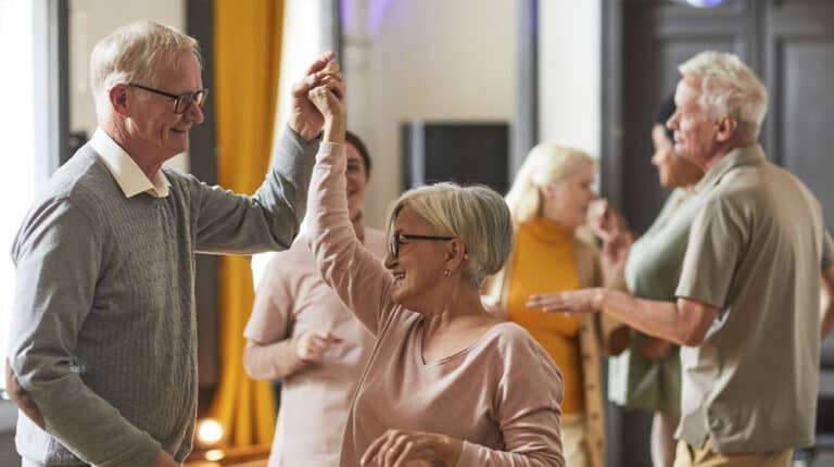 12Oaks-Group of smiling senior people dancing while enjoying activities in retirement home-as-4 Music Activities You and Your Seniors Will Enjoy Doing-Feature
