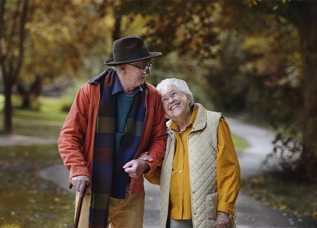 12Oaks-Happy senior couple in love walking in city park together-as-1. Walking