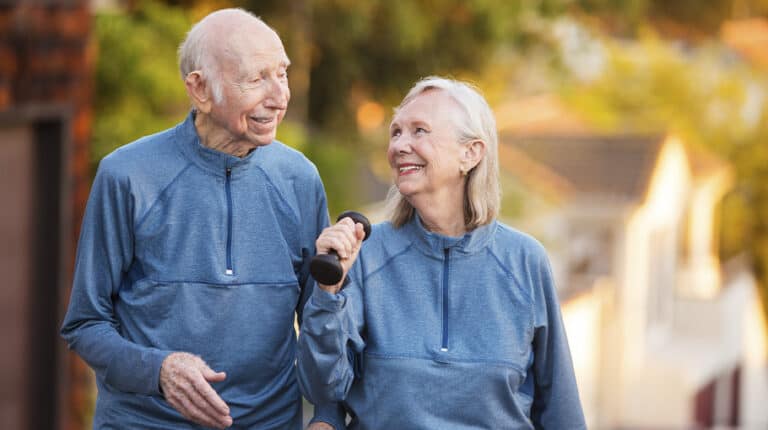 12Oaks-Joyful older couple walking outdoors-as-8 Best Activities And Sports Seniors Will Enjoy-Feature