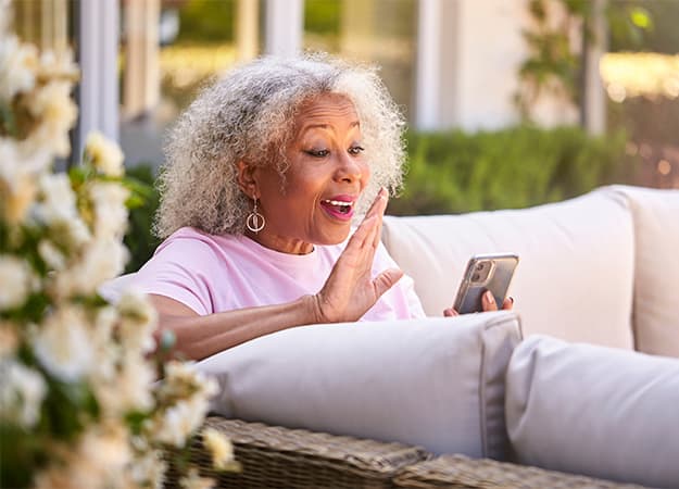 12Oaks-Senior Retired Woman Sitting Outside In Garden At Home Making Video Call On Mobile Phone-as-Where to Meet Your Potential Partner