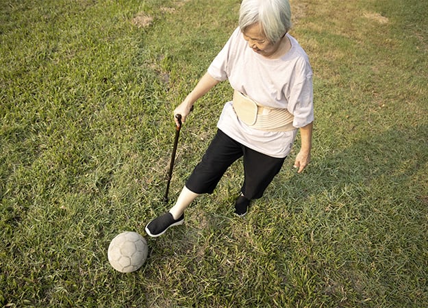 12Oaks-healthy female elderly is kicking soccer ball-as-5. Walking Soccer