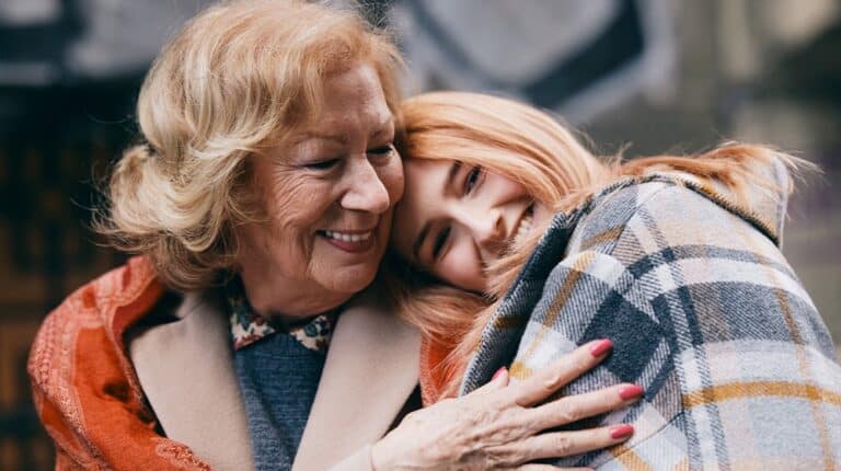 12Oaks-Grandmother and granddaughter hugging on the street in cold weather-ss-What to Include and Look Out for When Getting a Dementia Care Plan-Feature
