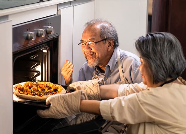 12Oaks-Asian Senior older couple grandparents making pizza in kitchen at home-as-Seasonal Toasty Pizzas