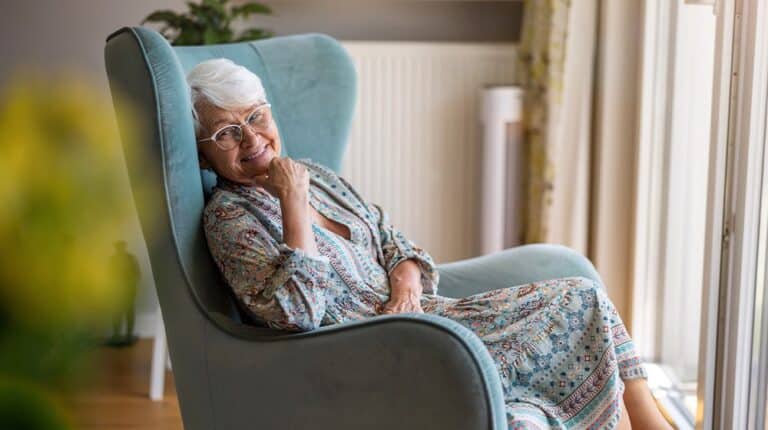 12Oaks-Elderly woman sitting in an armchair in her home-as-Assisted Living Decorating Ideas to Make Your Parents More Comfortable-Feature