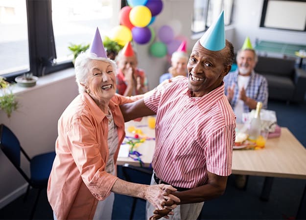 12Oaks Portrait of happy senior couple dancing at party as Keep Stress at Bay at 12 Oaks Communities