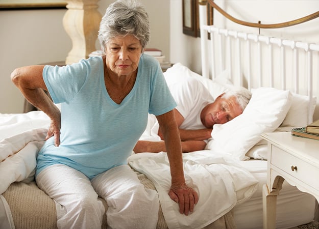 12Oaks-Senior Woman Suffering From Backache Getting Out Of Bed-as-Why Are Seniors Stressed Out_