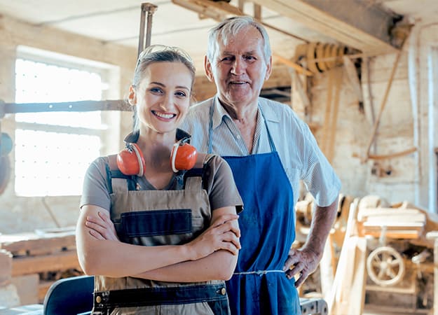 12Oaks-Senior master carpenter with his granddaughter in the wood workshop-as-What Were the Jobs That You Had in Your Life_