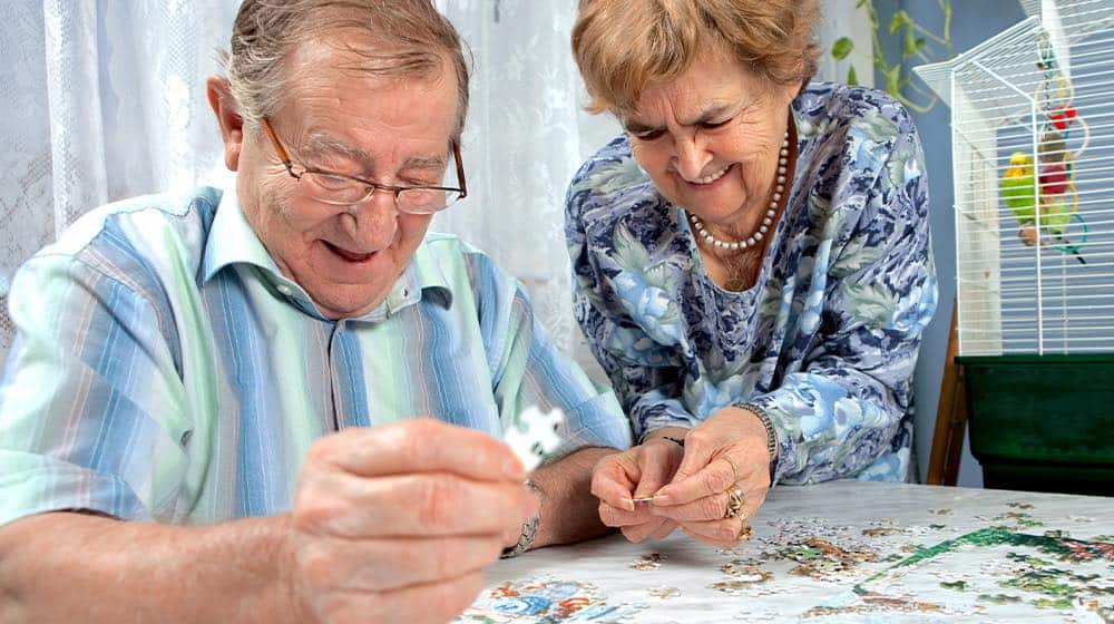 12OaksSenior couple working on a puzzle-as-Memory Games for Elderly Loved Ones to Keep Their Minds Sharp-Feature