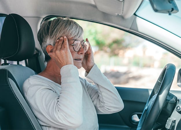 12Oaks-One senior or mature female people having and feeling bad headache in car while driving-as-2 They Are Diagnosed With Age-Related Eye Conditions