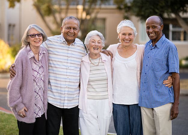 12Oaks-Portrait of cheerful senior people standing with arms around-as-2 American Association of Retired People (AARP)