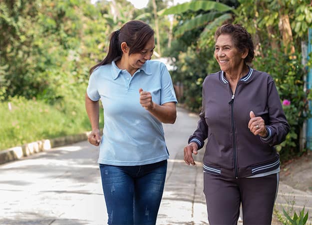 12Oaks-Cheerful elderly mother and daughter jogging outdoors in a morning exercise-as-5 Incorporating Nutrition Needs and Routine Exercises