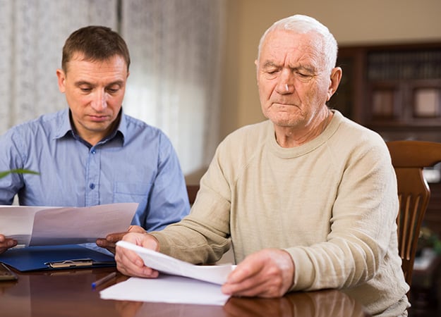12Oaks-Elderly man and his son organizing documents at home-as-1 Important Personal Information _ Documents