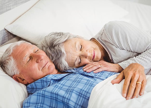 12Oaks-Senior couple sleeping on bed in bedroom-ss-5 Coloring Helps Seniors Sleep Better