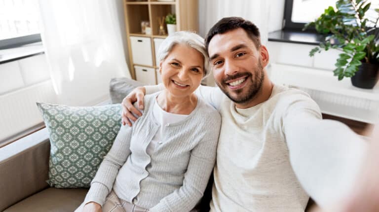 12Oaks-happy smiling senior mother with adult son taking selfie at home-as-Aging Parents Checklist- Things You Need to Keep an Eye Out For-Feature