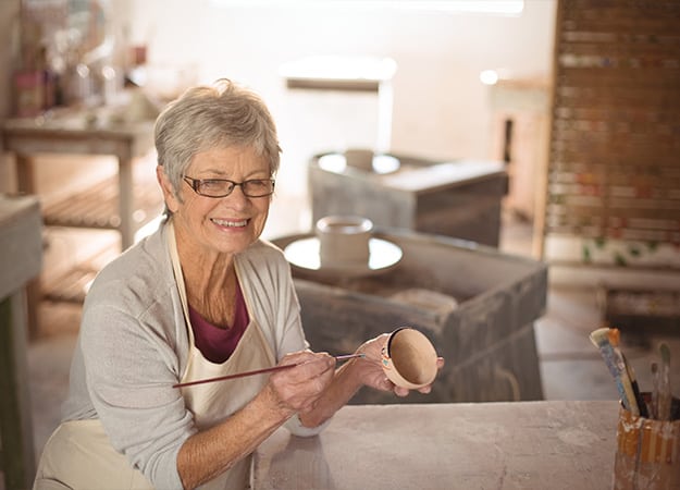 12Oaks-senior woman painting on bowl in pottery workshop-as-4 Try Something New