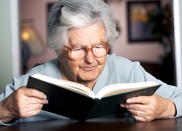 12Oaks-Elderly woman reading a book-as-5 Reading