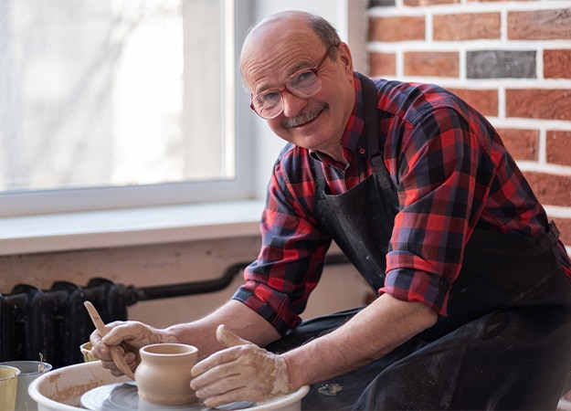12Oaks-Senior male potter creating bowl in pottery workshop-as-6 Indulging in Creative Endeavors