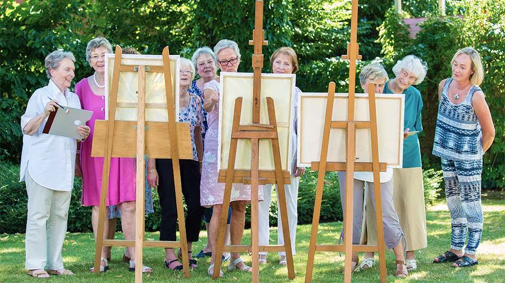 12Oaks-Senior women painting on canvas during sunny day.-as-Hobby Clubs Your Parents May Want To Consider To Socialize-Feature
