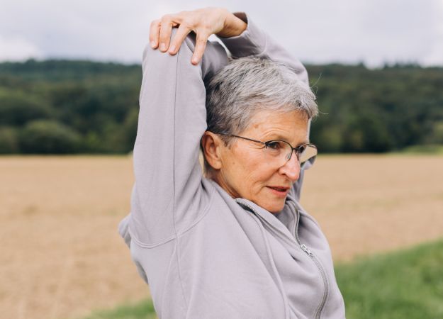 12Oaks-Elderly Woman Stretching Outdoor-Canva-13 Stretching Exercises for Seniors