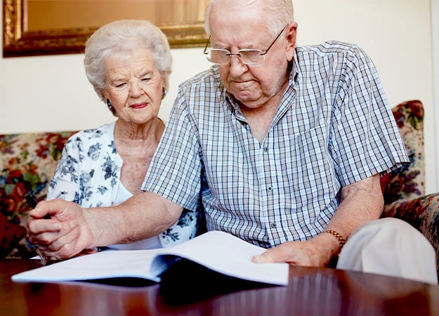 12Oaks-Mature couple going through some retirement paperwork-as-Estate Planning for Seniors-A Complete Checklist _ Issues to Consider