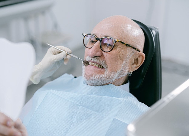 12Oaks-A man sitting on dental chair-pexels-6 Gum Disease
