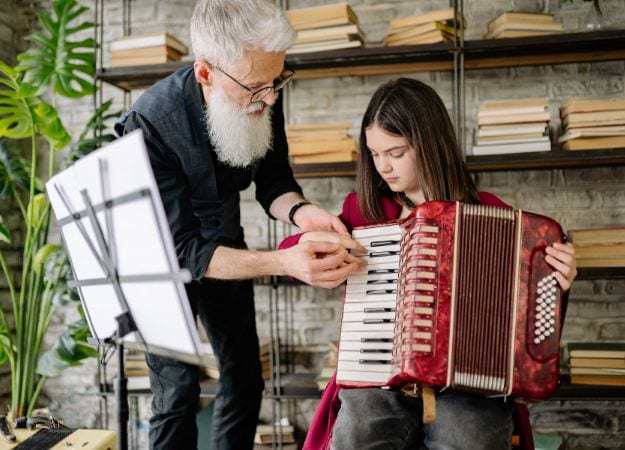 12Oaks-A man teaching a girl how to play accordions-canva-6 Reignite Old Interests